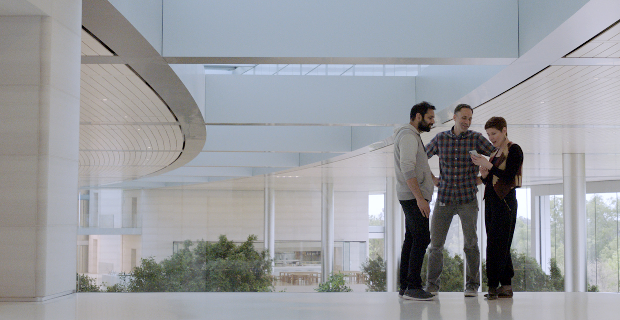 Cecile, an engineering manager at Apple, chats with other employees in an Apple office.