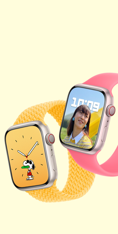 兩隻 Apple Watch Series 9。第一隻錶備有史諾比錶面並配上驕陽黃色編織單圈手環。第二隻錶備有人像錶面並配上粉紅色單圈手環。
