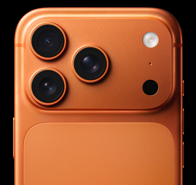 A back view of the top third of an iPhone 17 Pro in Cosmic Orange showing all three 48 MP cameras.