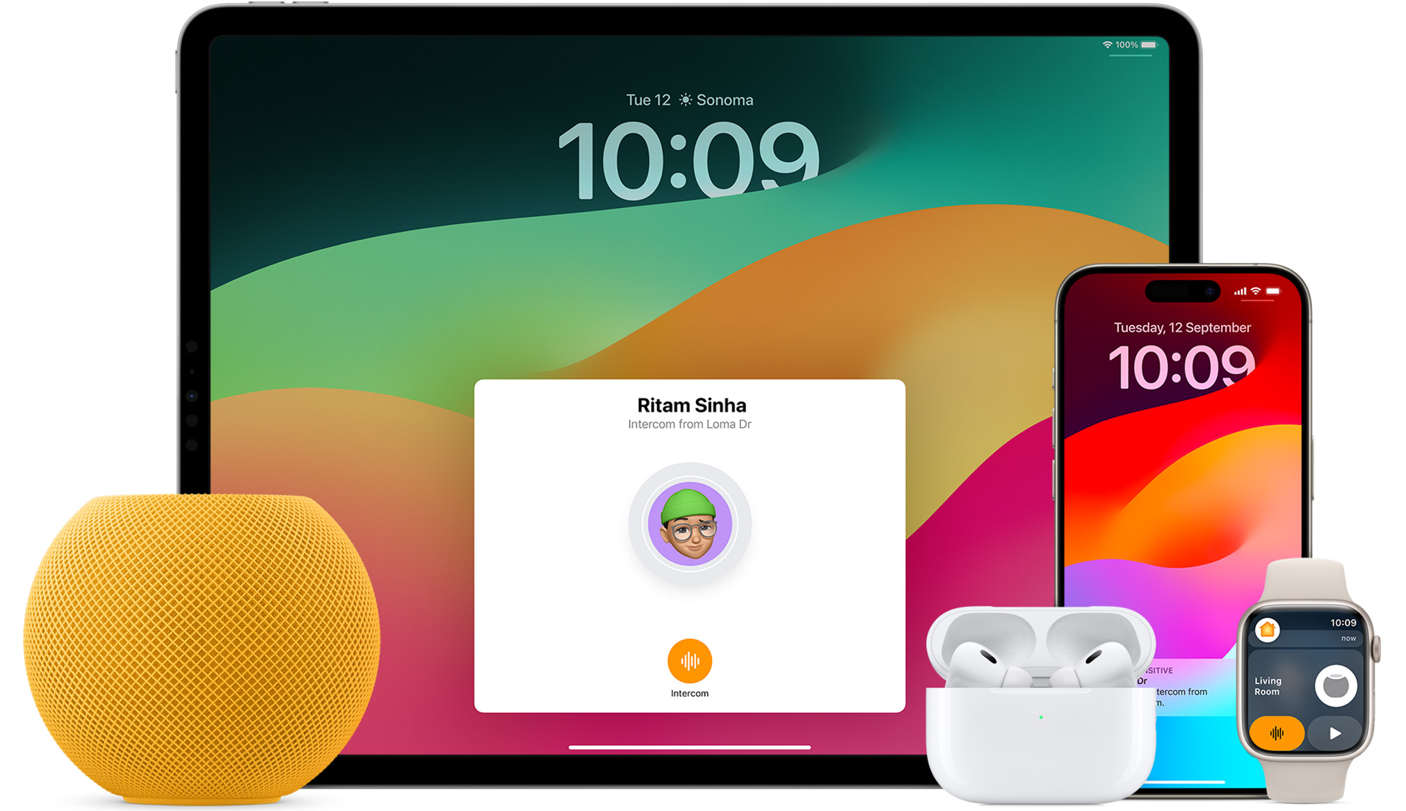 White HomePod mini, an iPad, AirPods in a case, an iPhone, and an Apple Watch with a pink band are arranged.