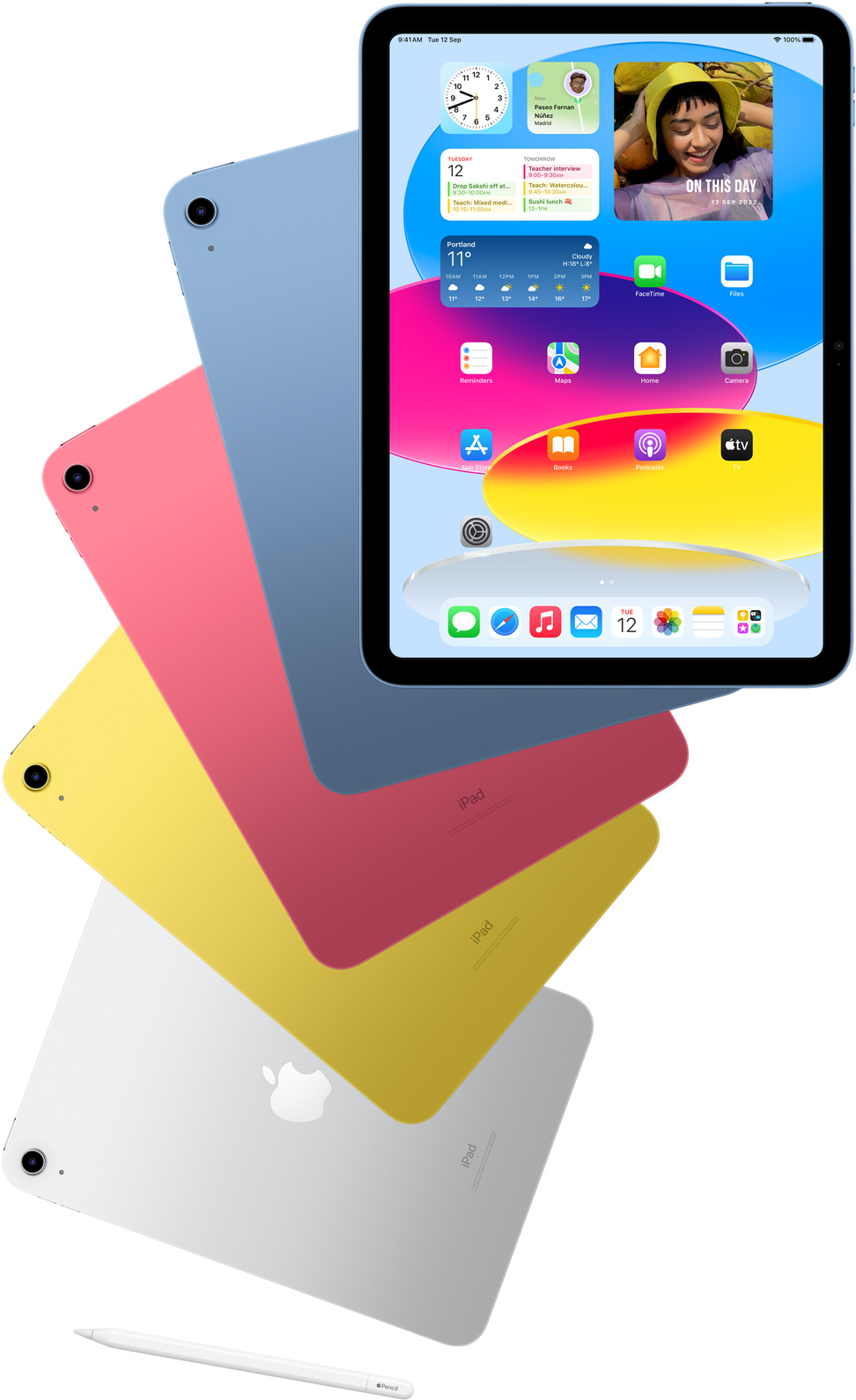 Front-view iPad shows home screen with blue, pink, yellow and silver rear-facing iPads behind it. An Apple Pencil sits near the arranged iPad models.