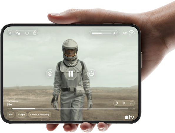 iPhone Duo, held with one hand, opened in horizontal orientation, fully unfolded, interior screen displays Apple TV show 'Silo'