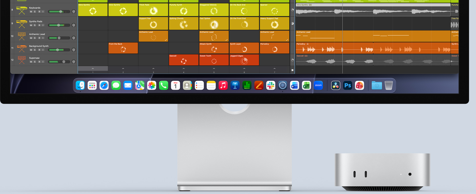 Mac mini front, tucked under Studio Display, with Logic Pro interface on screen, and productivity apps in Dock at the bottom