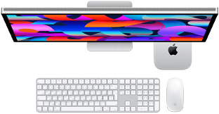 جهاز Mac mini موضوع تحت شاشة Studio Display، لوحة مفاتيح ماجيك مع لوحة مفاتيح رقمية، وماجيك ماوس