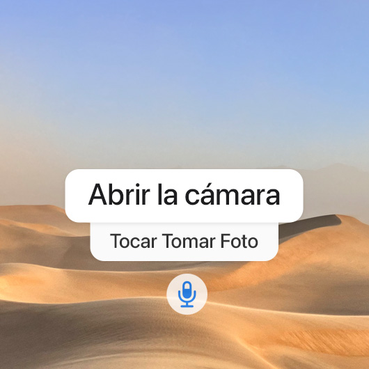 Imagen estática que muestra una secuencia de comandos de voz, “Abrir la cámara”, “Tocar Tomar Foto” en la interfaz de Control por Voz