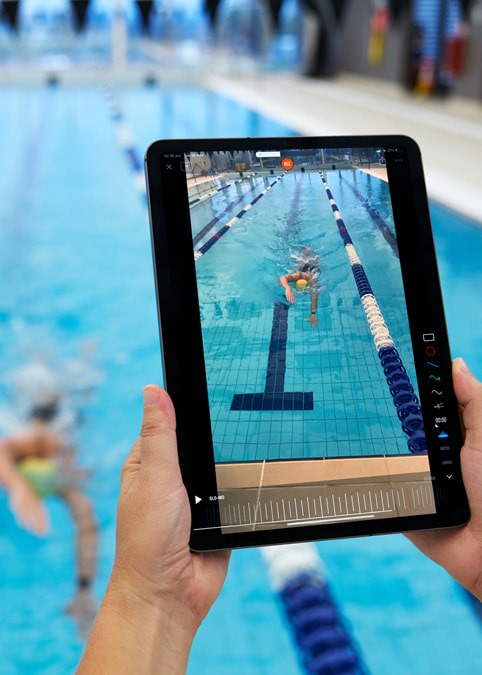 Swimming Australia’s coach recording race and training footage using the Camera app on iPad.