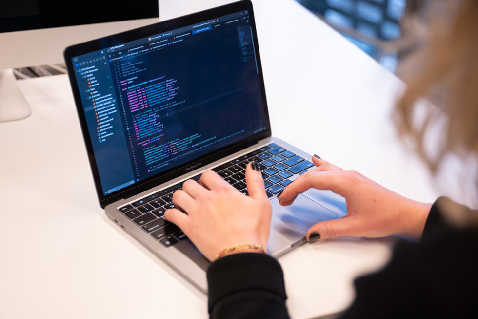 A UTS student coding on her MacBook Pro.