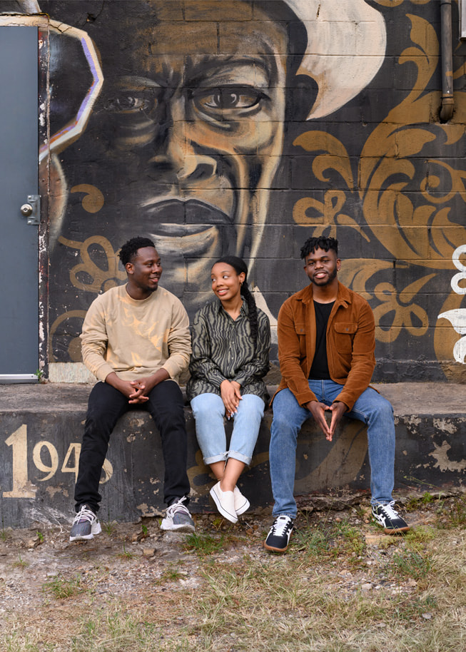 Die Apple Entrepreneur Camp Teilnehmer:innen Harold Lomotey, Ashley McKoy und Ositanachi Otugo vor einer bemalten Wand in Austin, Texas.
