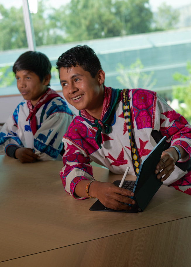 Hugo Enrique Montes de la Cruz og Filiberto de la Cruz, studenter ved Universidad de Guadalajara; de la Cruz Ramirez, holder en iPad og en Apple Pencil.
