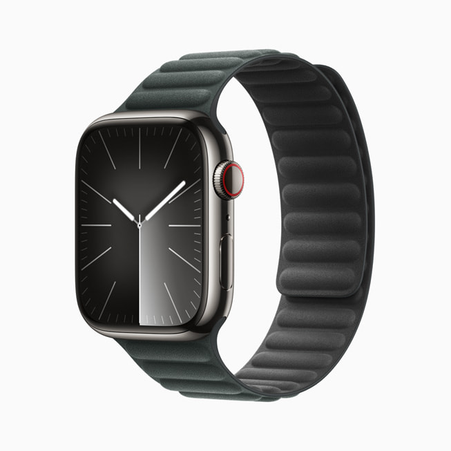 Apple Watch Series 9 in stainless steel in graphite with a green FineWoven Magnetic Link band.