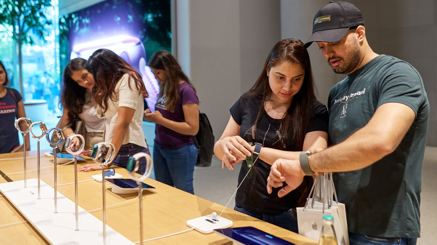 Customers trying on the new Apple Watch Series 9.