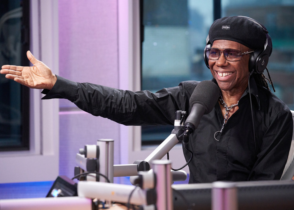 Artwork for Nile Rodgers’s Deep Hidden Meaning Radio show on Apple Music. Image shows host Nile Rodgers seated in front of a microphone.