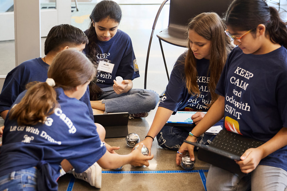 Soleil (far left) and Lluvia San Miguel (second from right) using iPad at the Houston Community College technology summer camp. 