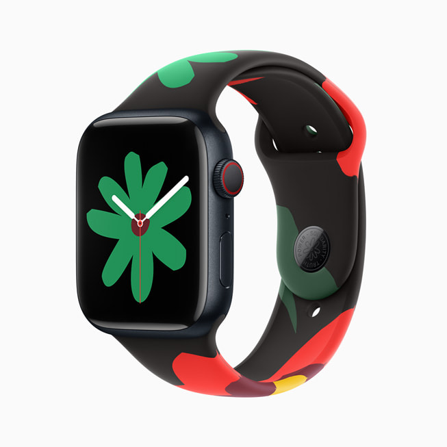 圖片顯示 Apple Watch Series 9 搭配全新 Black Unity 系列錶帶和錶面；在這張圖片中，錶面有一朵較小的綠色花朵。