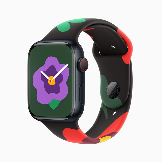Apple Watch Series 9 is shown with the new Black Unity Collection band and face; in this image, the face has a smaller purple flower.