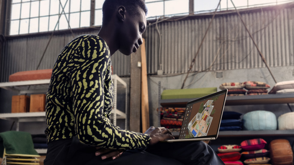 A person uses the new MacBook Air in a studio space.