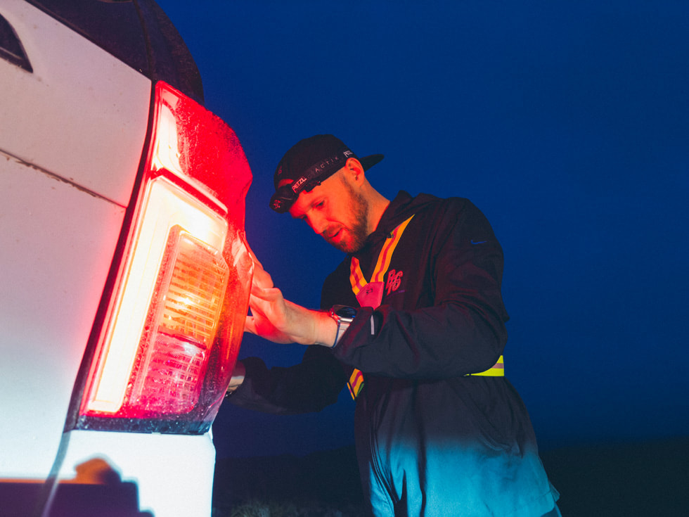 Will Eckman s’étire en prenant appui sur une voiture.