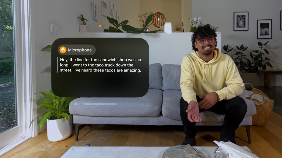 The Live Captions experience in visionOS is shown from an Apple Vision Pro user’s point of view.
