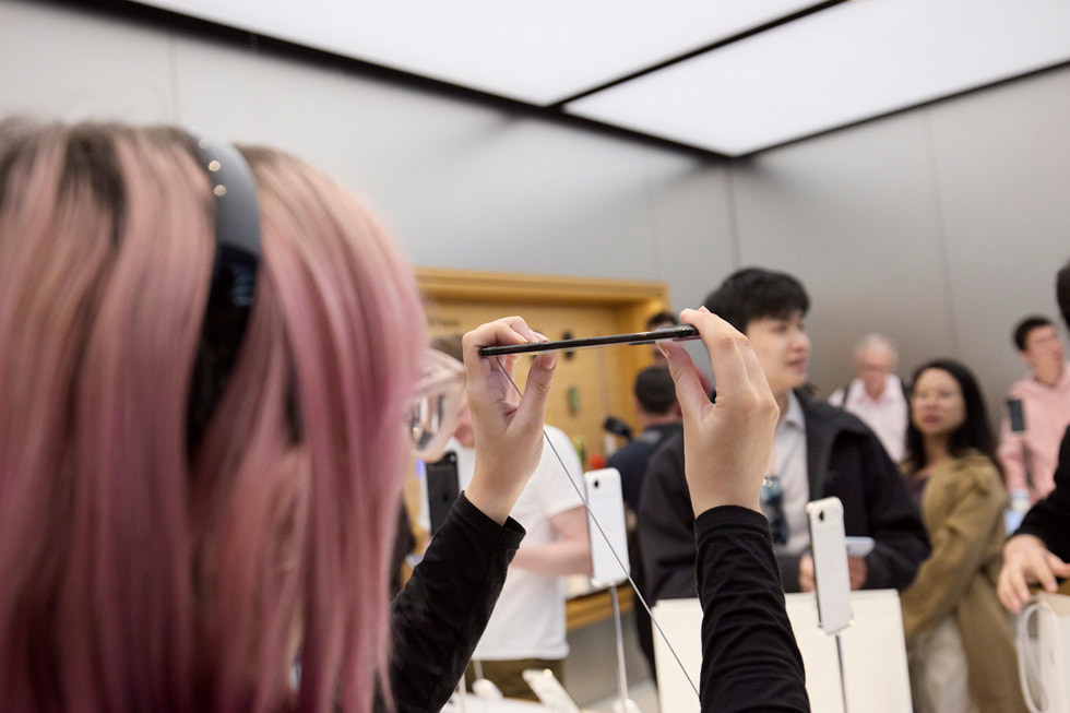 A customer holds up iPhone Air to take a closer look at it at the Apple Sydney store in Sydney, Australia.