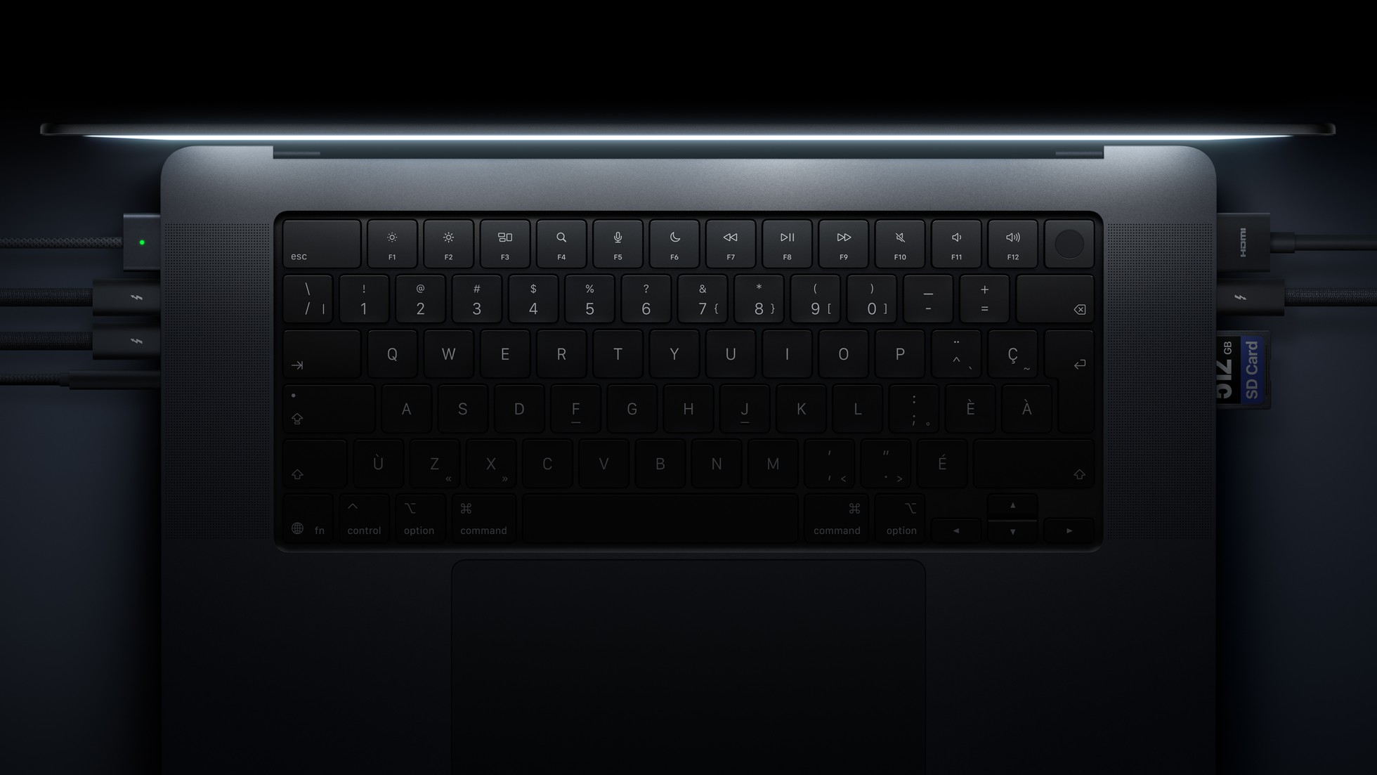 MacBook Pro keyboard and trackpad with accessories connected