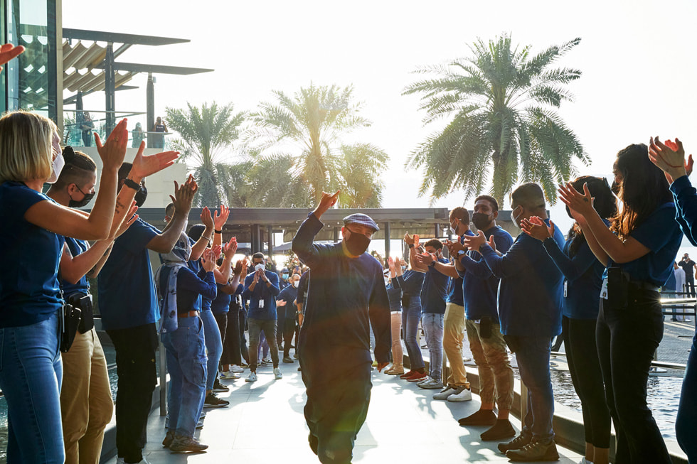 Apple team members welcome the first customers at the grand opening of Apple Al Maryah Island.