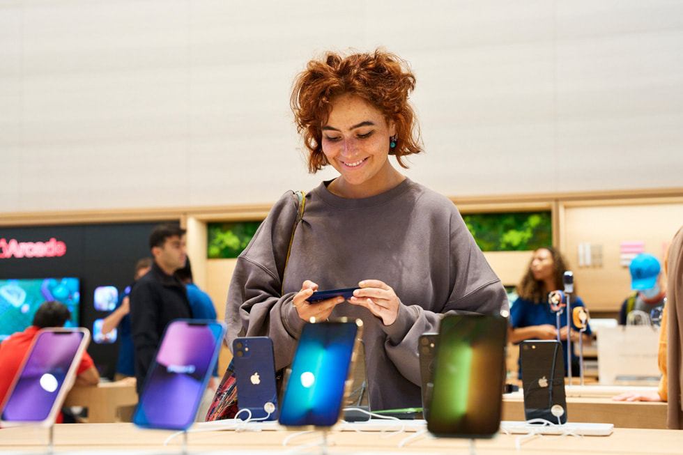 A customer takes a look at the iPhone line-up at Apple Brompton Road.
