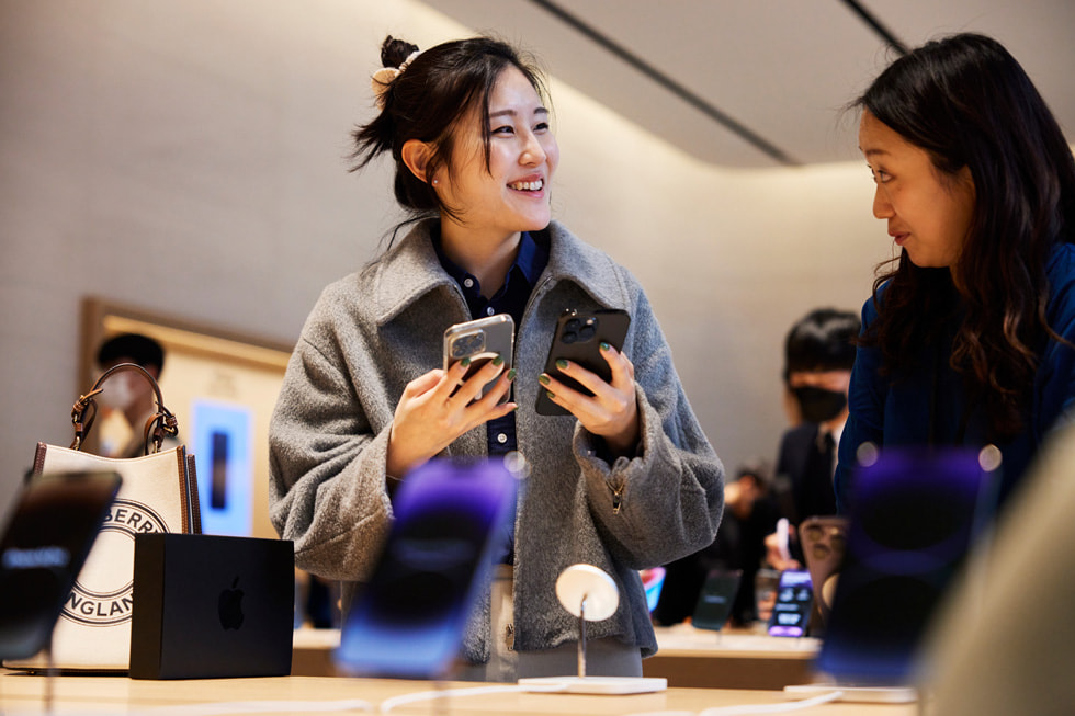 A customer holds up the new iPhone 14 Pro at Apple Gangnam in Seoul.