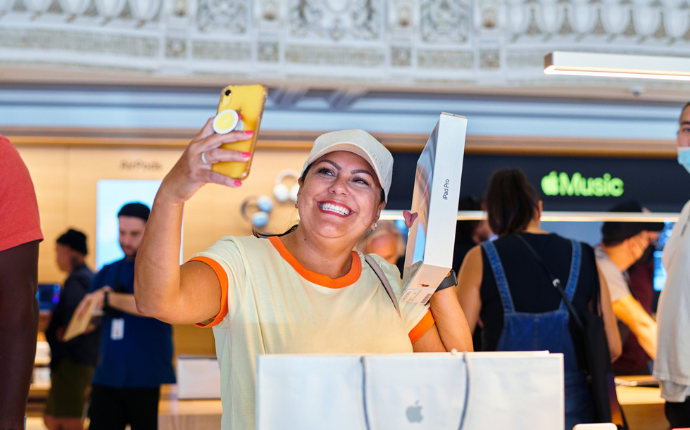 Una cliente di Apple Tower Theatre festeggia l’acquisto di un nuovo iPad Pro con un selfie.