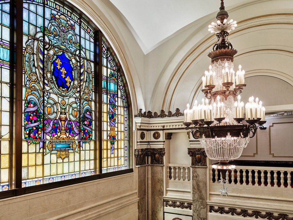 The chandelier and stained-glass window at Apple Tower Theatre.