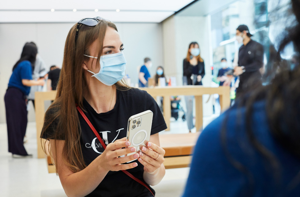 A customer at Apple Sydney with iPhone 12 Pro Max housed in a Clear Case with MagSafe.