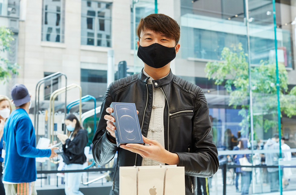 A customer at Apple Sydney is all smiles with his new iPhone 12 Pro Max purchase. 