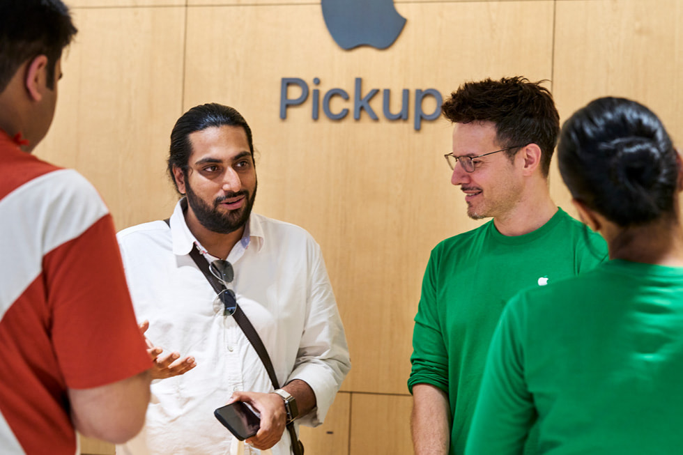 Teammitglieder mit Kunden im Apple Pickup Bereich in Apple Saket.

