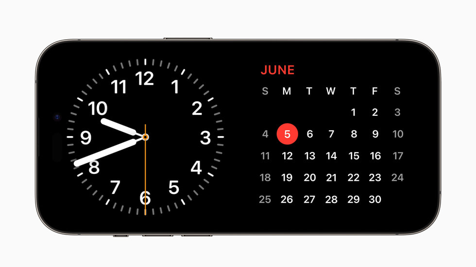 StandBy sur un iPhone 14 Pro équipé d’iOS 17, affichant une horloge et une vue de calendrier.