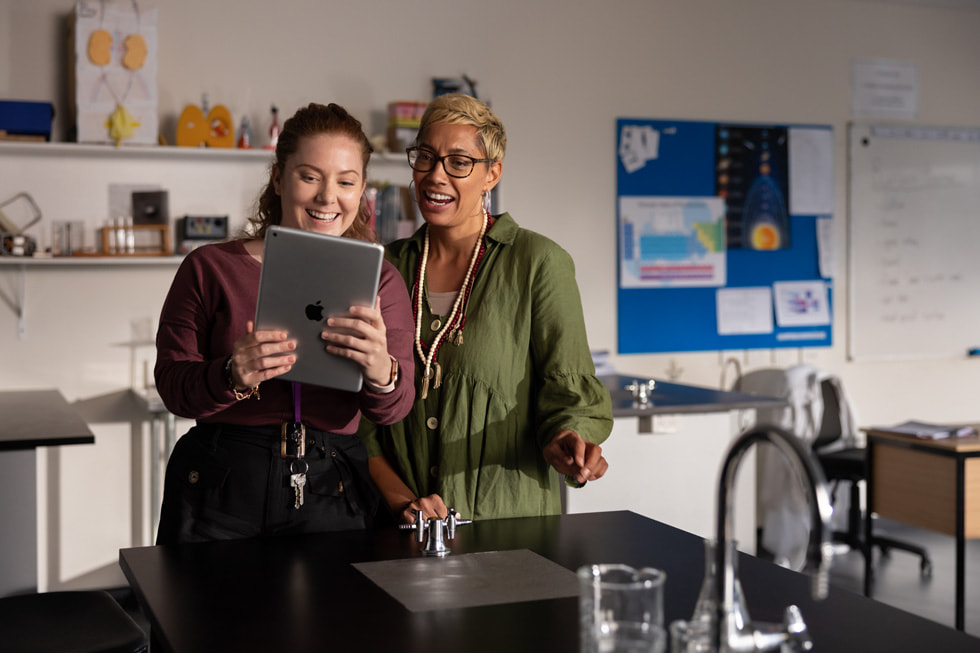 An educator coaching a teacher on iPad.