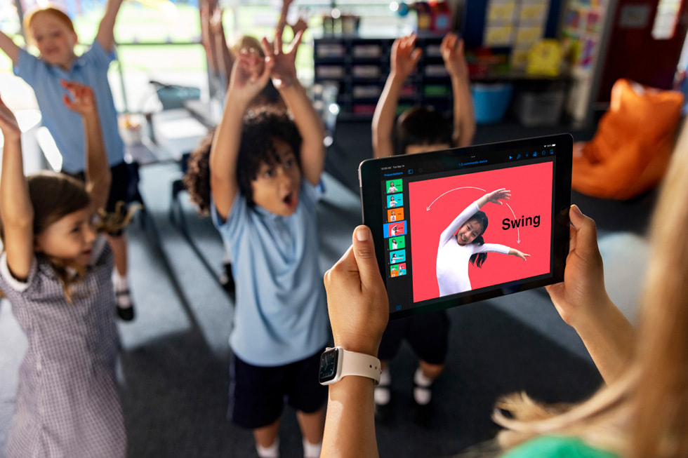 Students participate in a lesson on coding commands taught through dance moves in a classroom setting.