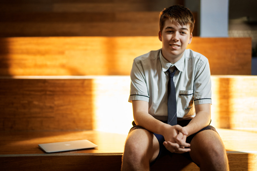 Lincoln Hetherington of St Augustine’s College, seated next to his MacBook Air.