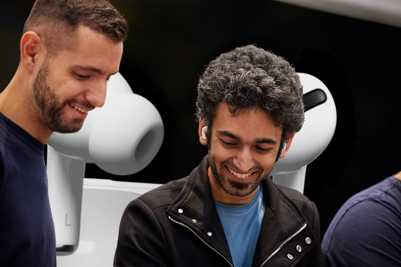 An Apple Piazza Liberty team member assists a customer with AirPods Pro.