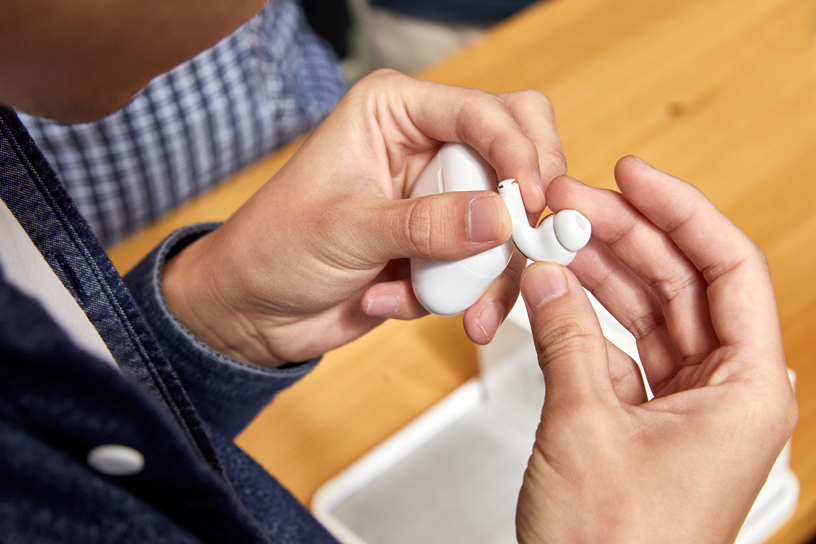 A customer holds AirPods Pro.