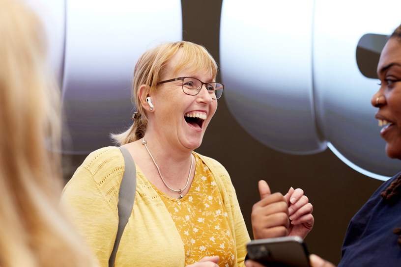 An Apple team member greets the first AirPods Pro customers at Apple Regent Street in London. 