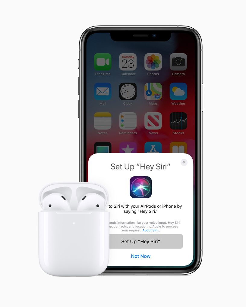 AirPods nella custodia accanto a un iPhone.