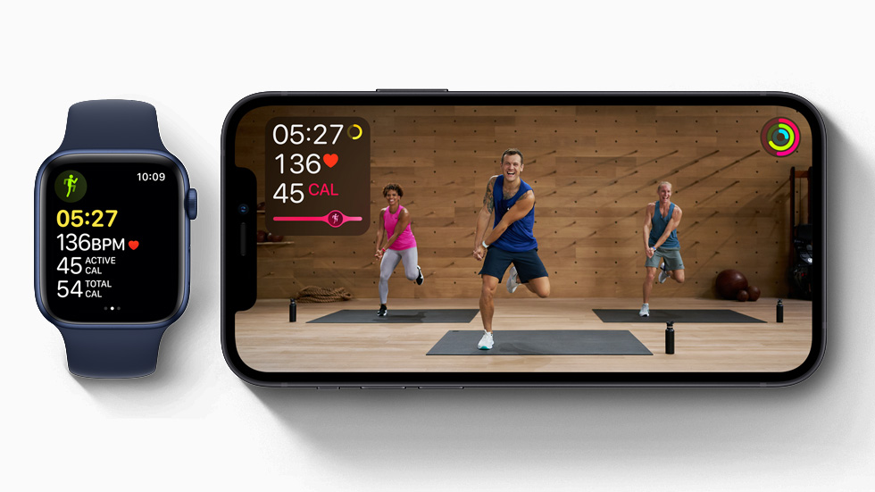 Apple Fitness + Studio workout displayed on iPhone 12, and workout in progress on Apple Watch Series 6.