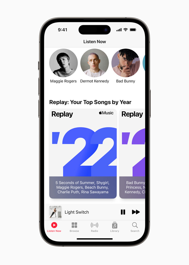 A user’s top songs organized by year in Apple Music is shown in Replay on iPhone.