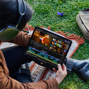 A person uses Final Cut Pro for iPad outdoors.