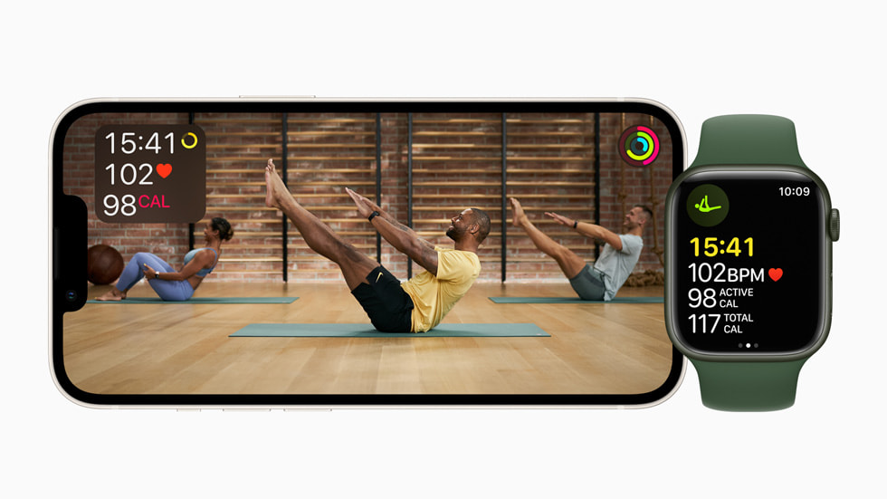 A horizontal iPhone screen shows a Fitness+ Pilates session alongside Apple Watch Series 7.