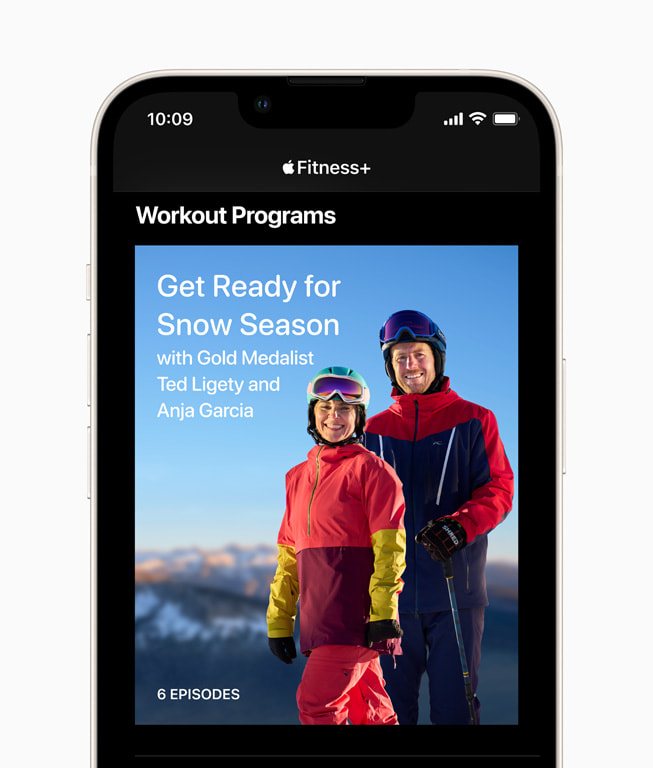 An iPhone screen shows the home screen for Get Ready for Snow Season with Ted Ligety and Anja Garcia in Fitness+.