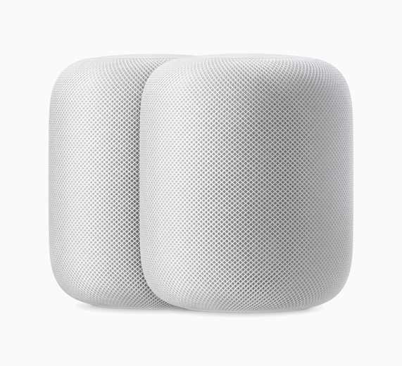 A photo of two white HomePods sitting side by side.