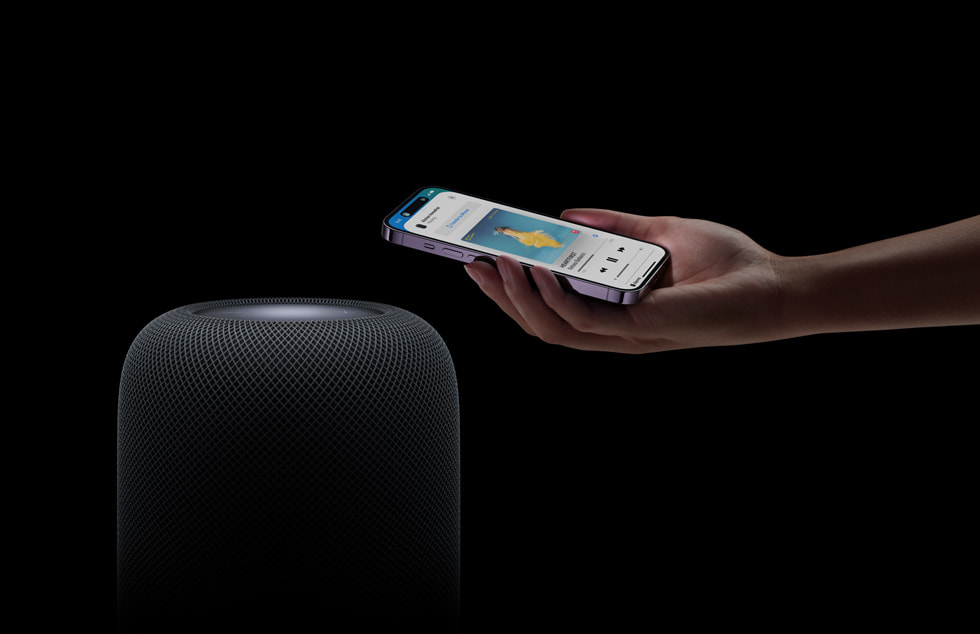A user holds their iPhone over HomePod (2nd generation).