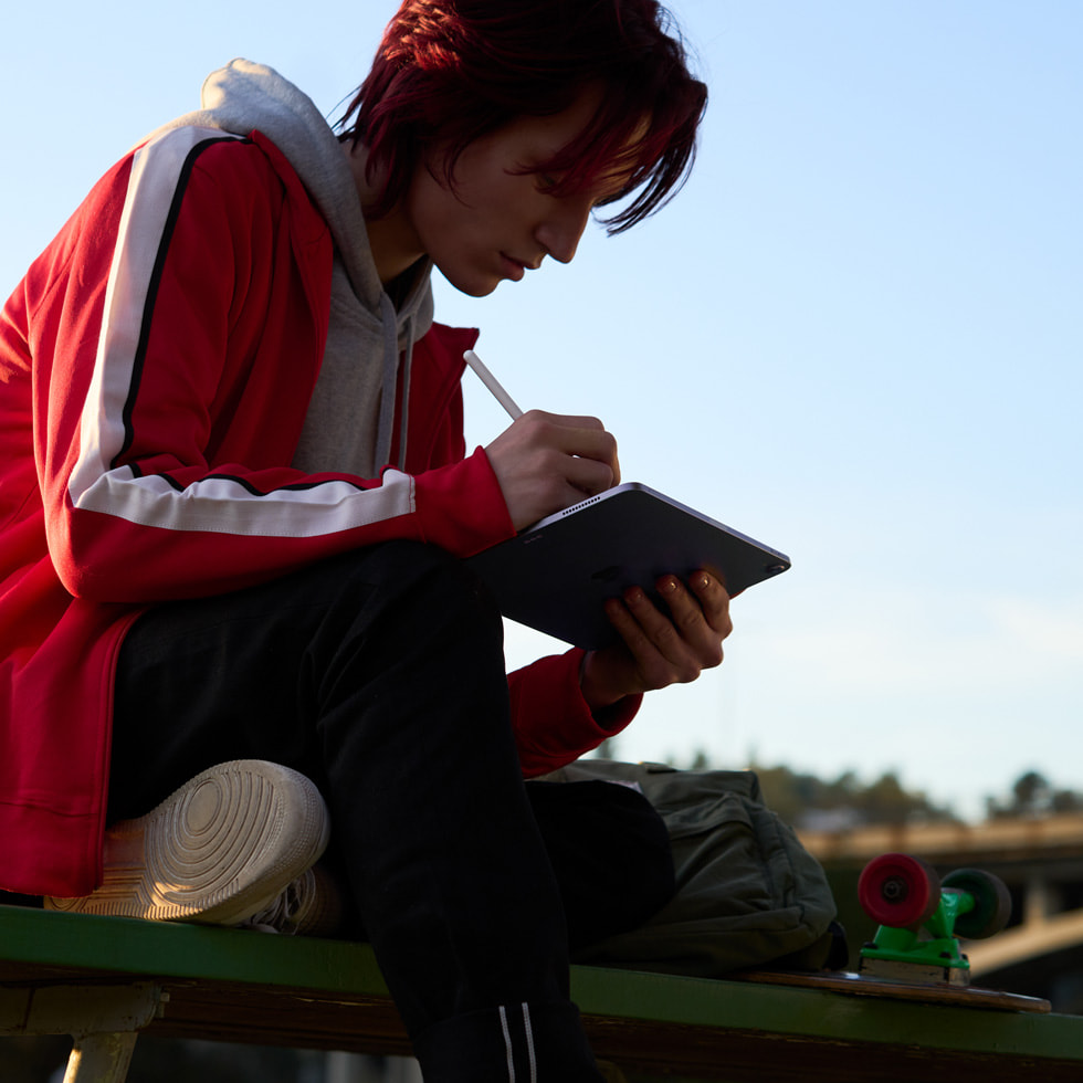 A person using Apple Pencil on the new iPad Air.