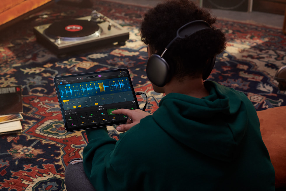 A person using Logic Pro on iPad indoors.