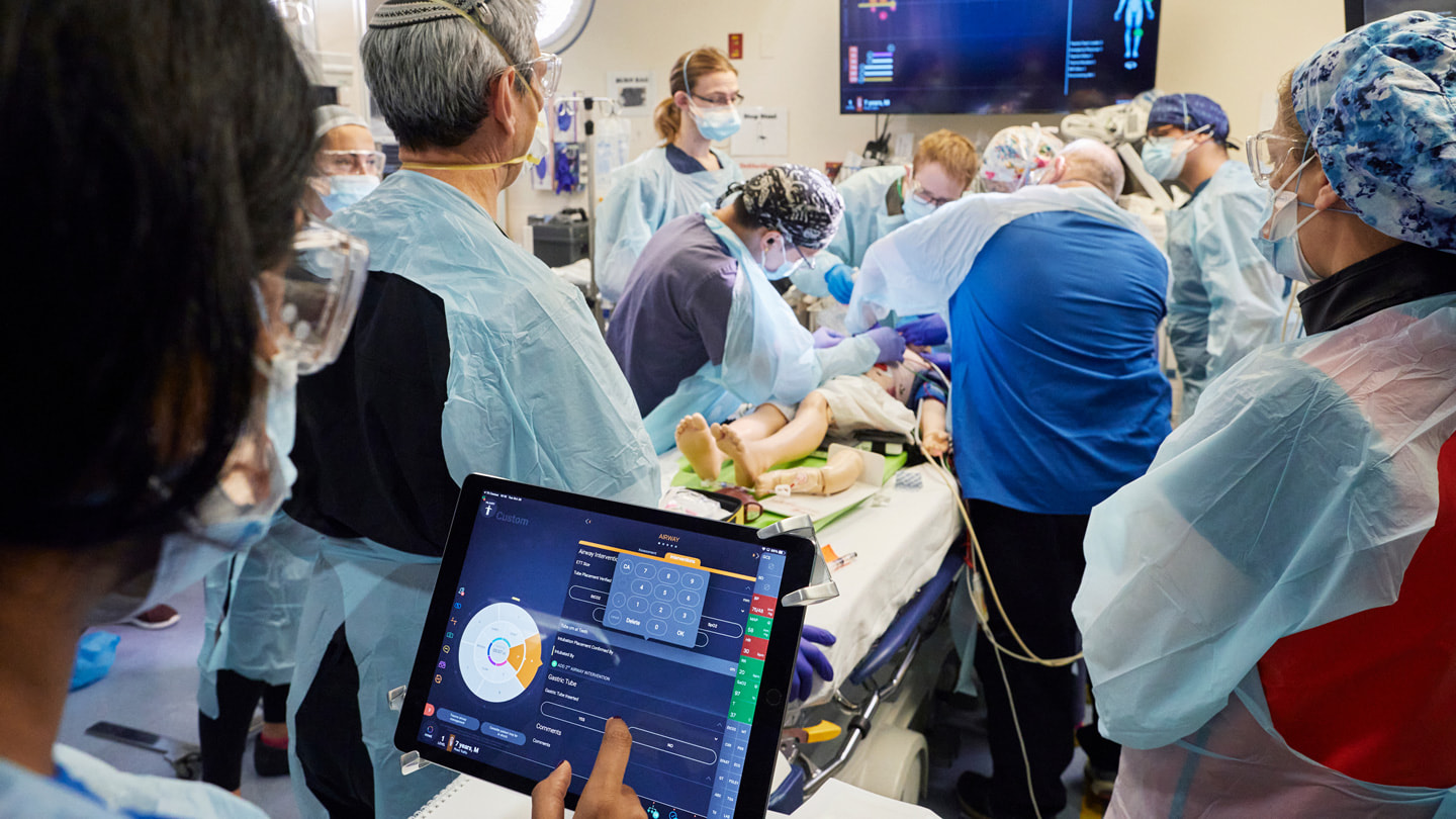 A 12-person trauma team works on a simulation at Cohen Children’s Medical Center in New York City.